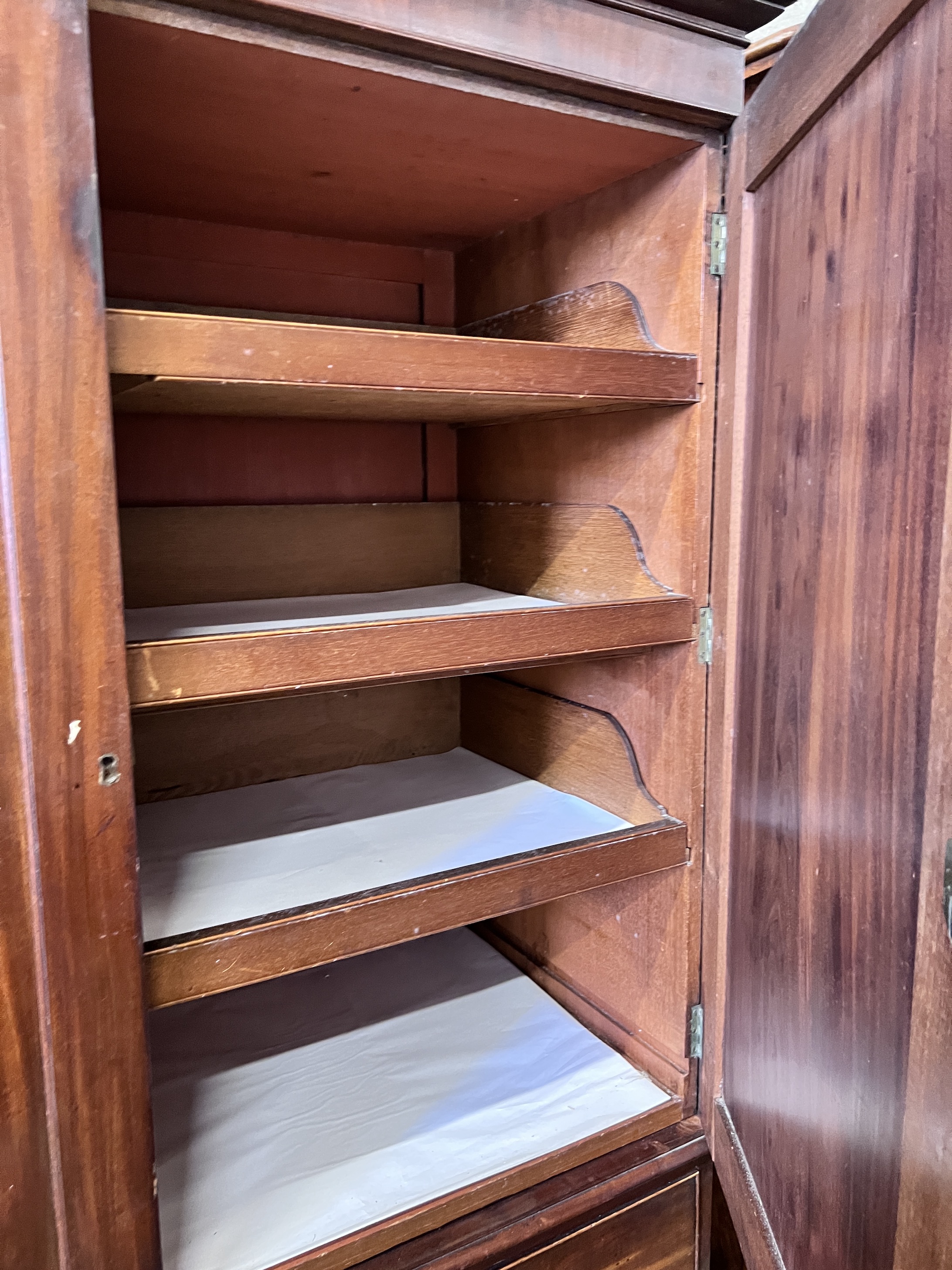 A George III mahogany linen press with two doors enclosing three adjustable shelves, width 125cm, height 205cm